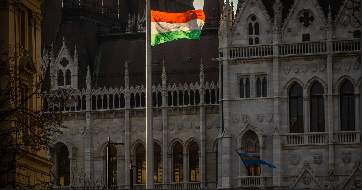 A flag flying in front of the Hungarian Parliament Building